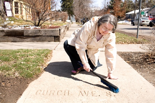 Kay McAllister sweeps off a misspelled sidewalk marker in Bozeman. Kay McAllister sweeps off a sidewalk marker to reveal a mispelled Church Street on Friday. McAllister has documented much of Bozeman's century-old sidewalk markings and is in booklet form at the Pioneer Museum.