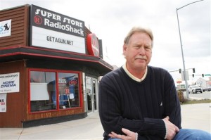 Steve Strand, who has owned the Radio Shack in Hamilton, Mont. for seven years, poses in front of his store Tuesday, March 29, 2011.  Strand said he is going to fight any effort to stop his sales promotion that allows customers with a clean record to get a free gun when they sign up for new Dish Network service. (AP Photo/Ravalli Republic, David Erickson)